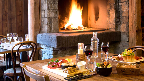 set table with dinner on the fireplace in the tel in our hotel La Marmotte - Places to stay in Morzine